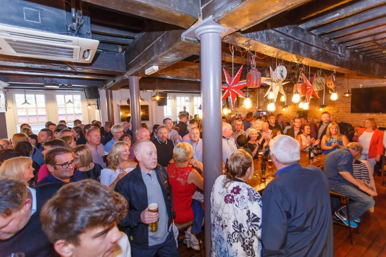 a large crowd of people standing in a room at Fenwick Sunrise Hotel in Liverpool