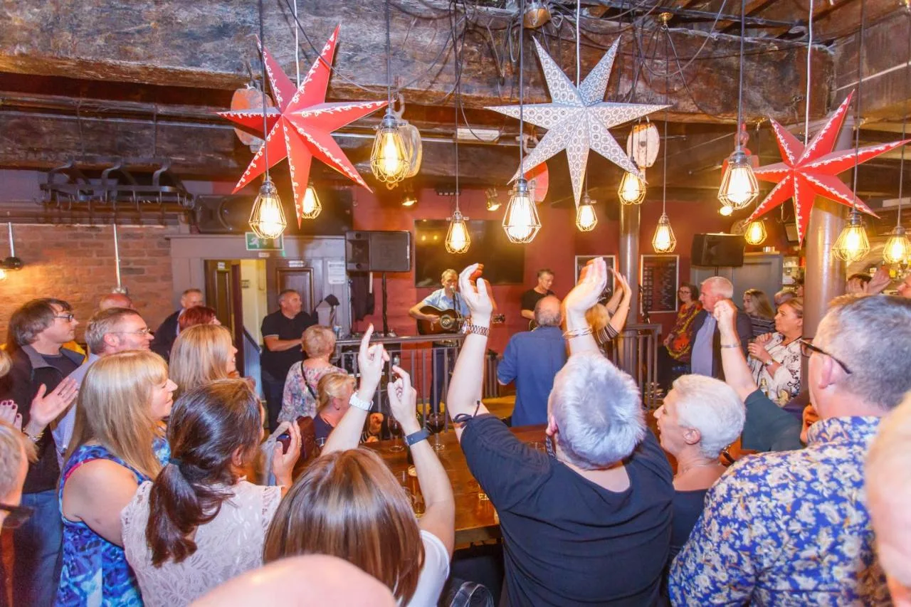 a crowd of people dancing in a room with stars at Fenwick Sunrise Hotel in Liverpool